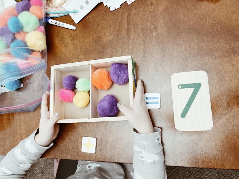 child using math manipulatives to solve a homeschool math problem