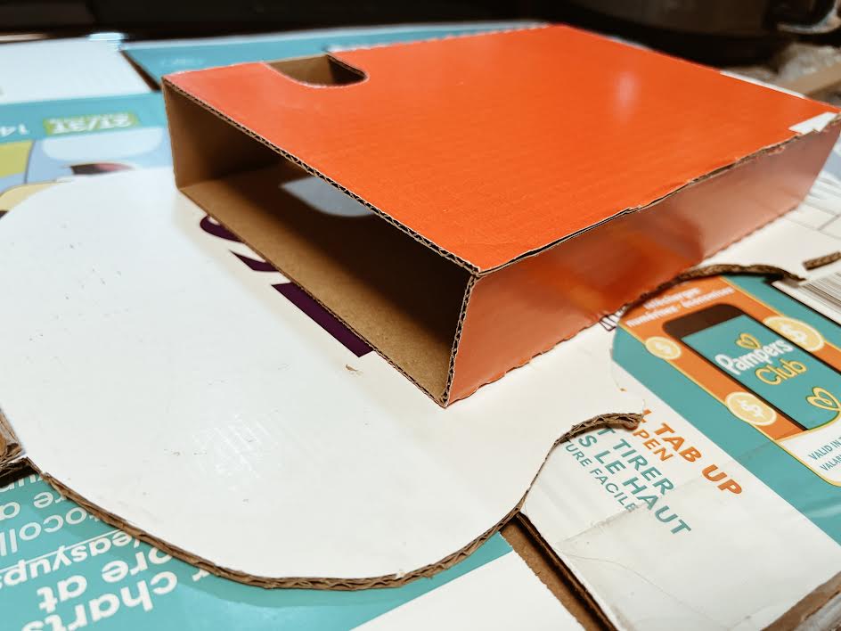 box glued to back of cardboard cello body to give it depth