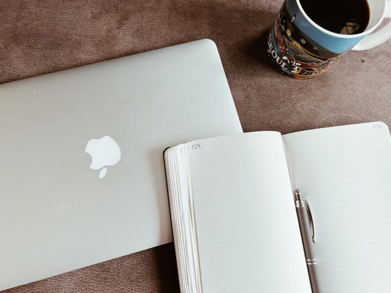 laptop, coffee and notebook for working while homeschooling