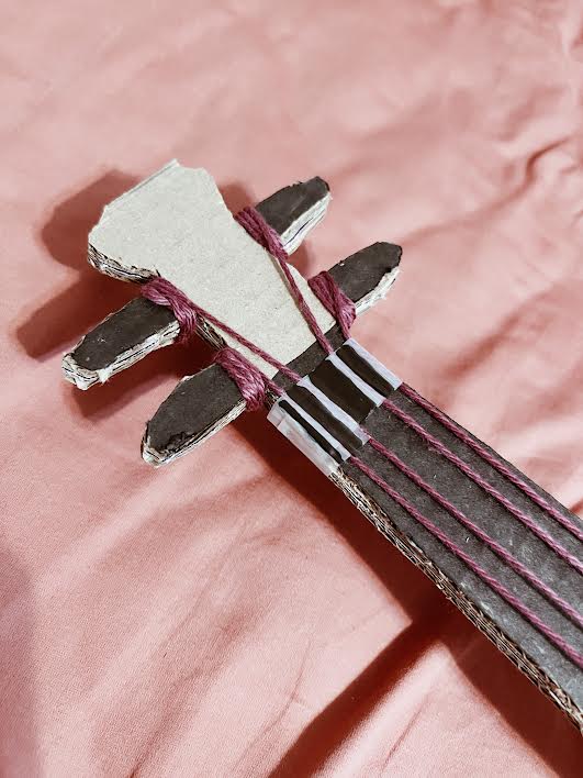 cardboard cello - finished scroll with yarn for strings