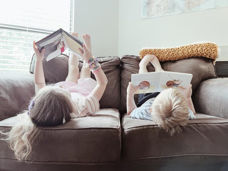 kids reading on couch during the summer