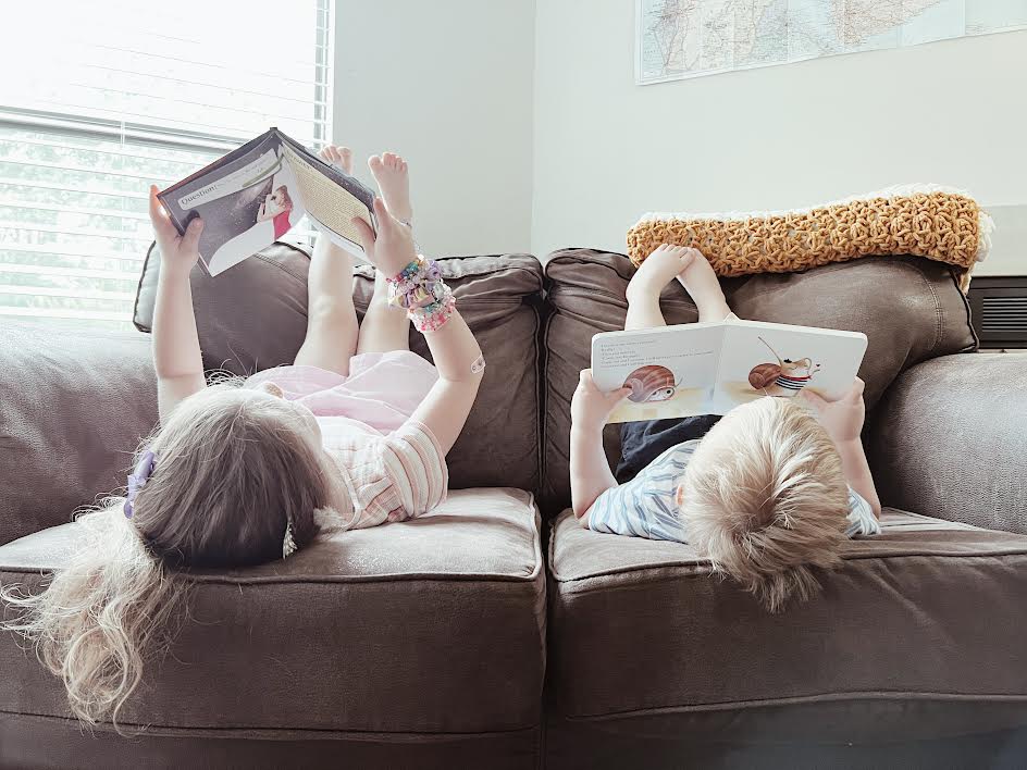 kids reading on couch during the summer