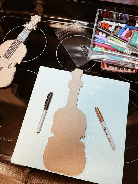 cutting cardboard for step 1 of diy cardboard viola